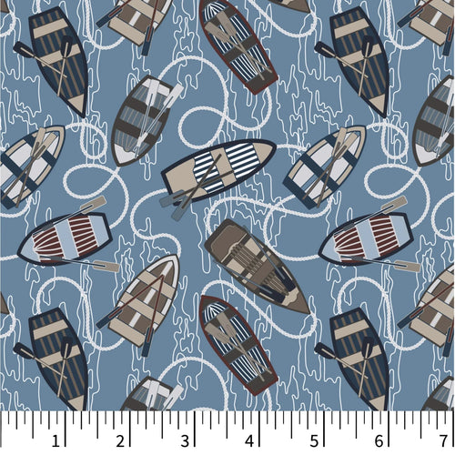Pattern of small boats on a blue background with a ruler at the bottom.